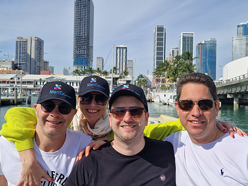 the 4 founders of the company wearing nice caps with the company-logo